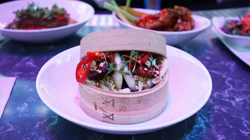 Assorted dishes including bao buns presented on a table