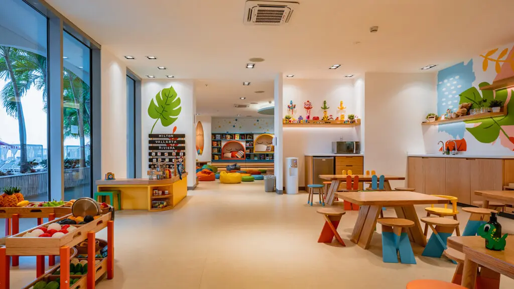 Colorful play space for kids with craft tables and other games