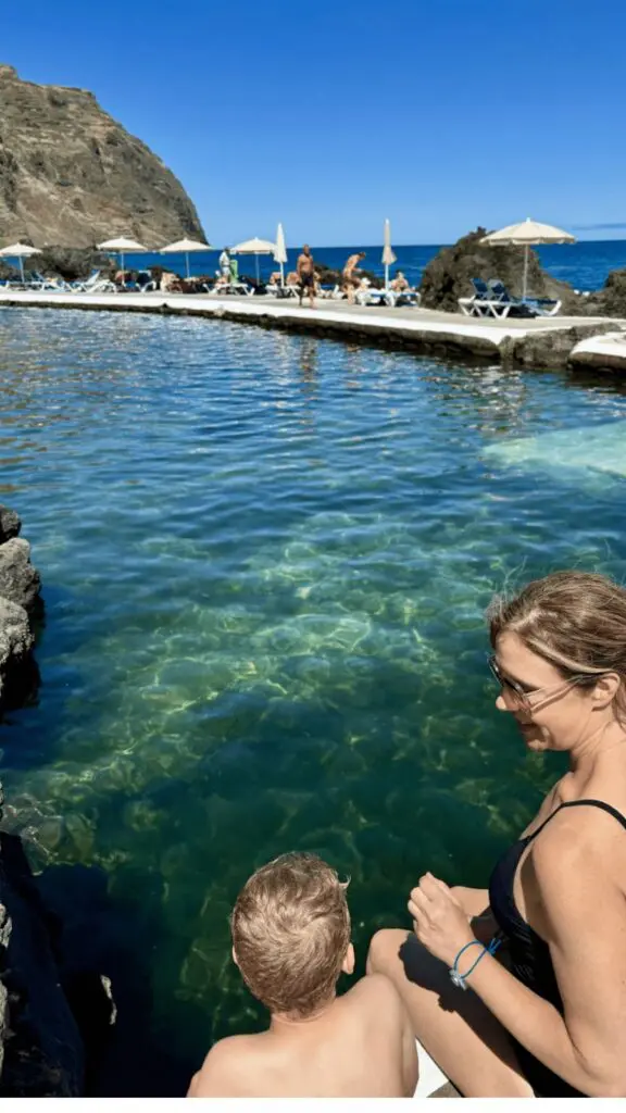Carley Thornell and her son seated by the water in Madeira
