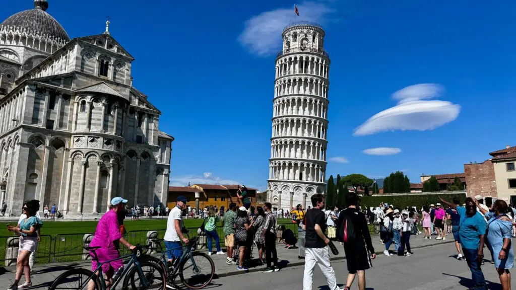 Crowd walking near the Leaning Tower of Pisa in Pisa Italy on a summer day