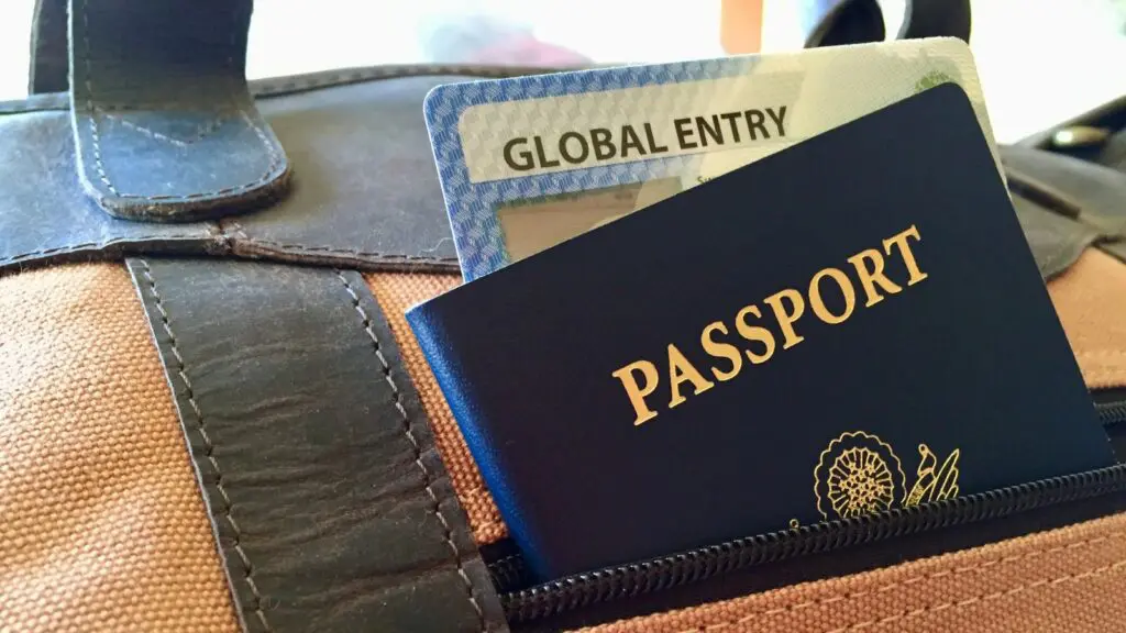 passport and global entry card peeking out of travel bag