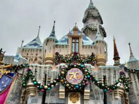 View of Disneyland castle decorated for holidays during its 70th anniversary