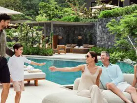 A multigenerational family sitting by the pool at Waldorf Astoria Costa Rica Punta Cacique