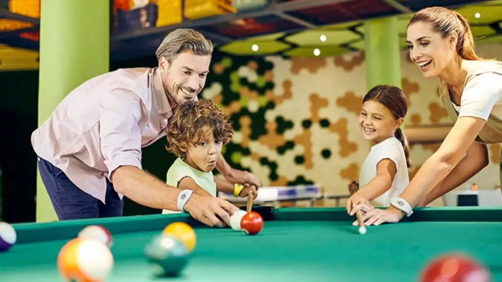 A family playing pool at Hotel Xcaret Mexico