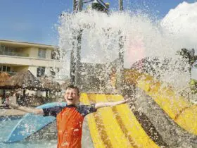 A kid getting splashed at a kids pool at Moon Palace Cancun