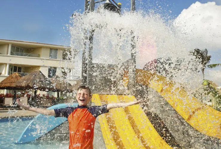 A kid getting splashed at a kids pool at Moon Palace Cancun