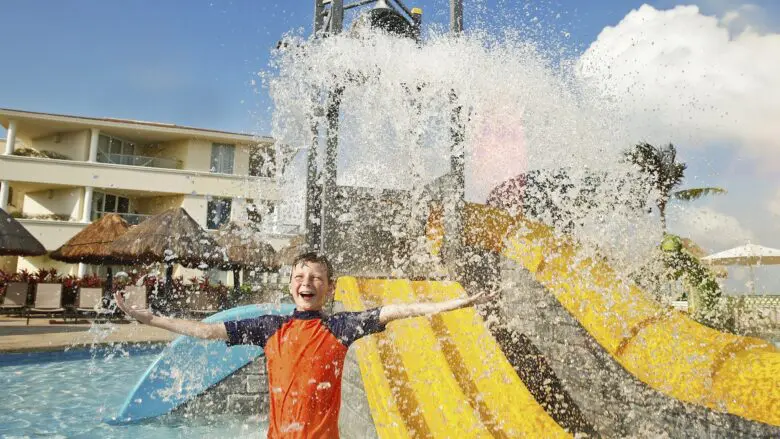 A kid getting splashed at a kids pool at Moon Palace Cancun