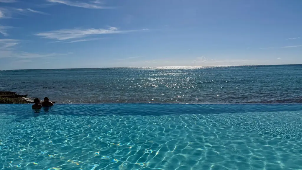people lounging in an infinity pool at Club Med Punta Cana
