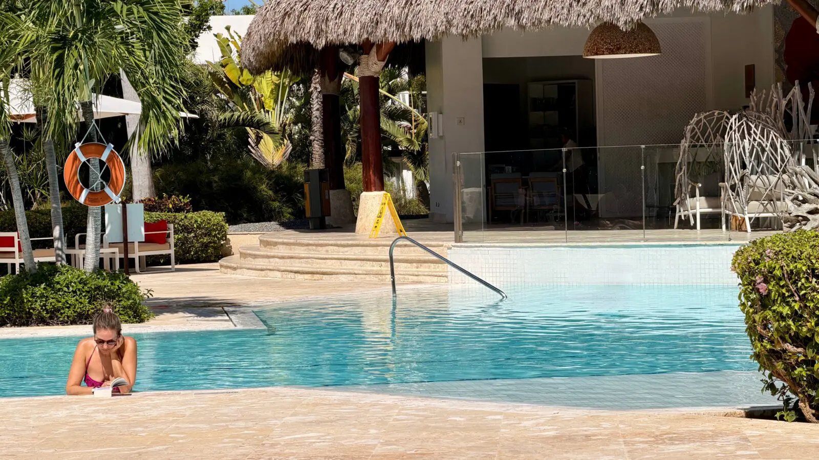 French person reading a book in the pool at Club Med Punta Cana