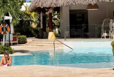 French person reading a book in the pool at Club Med Punta Cana
