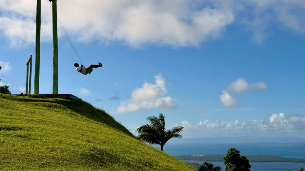 person on swing overlooking Miches in Dominican Republic