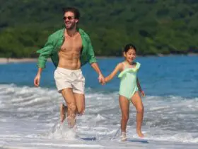 A parent and child on the beach at The Westin Reserva Conchal