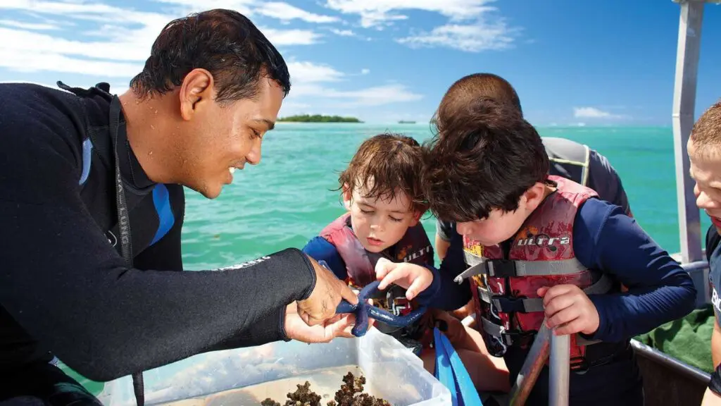 Kids looking at marine life at Jean-Michel Cousteau Resort in Fiji