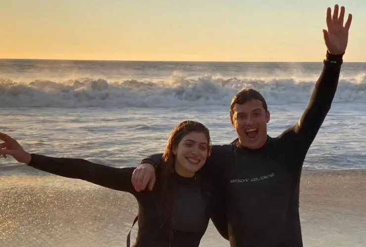 Teens after a sunrise surfing lesson in Hawaii