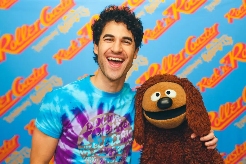 Darren Criss and Rowlf the Muppet as seen in the queue for Rock 'n' Roller Coaster Starring The Muppets