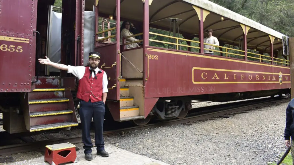 Skunk Train conductor with train in the station
