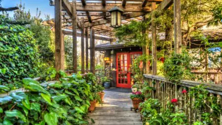 Stanford Inn walkway with lush gardens and red door