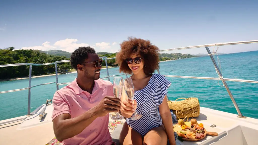 A couple toasting on a boat in Jamaica