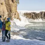 Three people taking a selfie during the winter at Presque Isle Park in Marquette County, Michigan