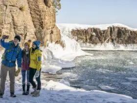 Three people taking a selfie during the winter at Presque Isle Park in Marquette County, Michigan