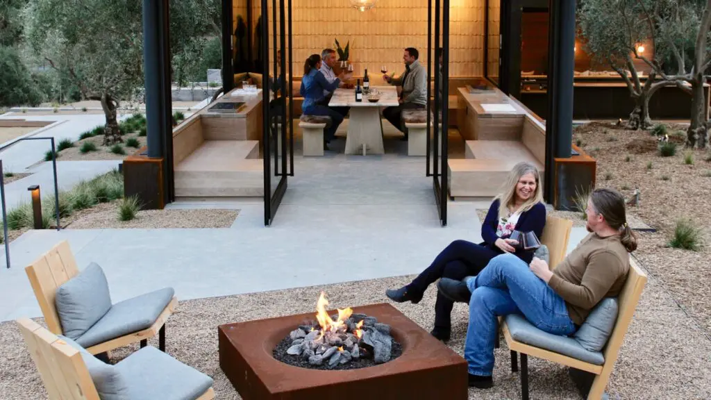 People around at firepit and at a table at Booker Vineyard in SLO