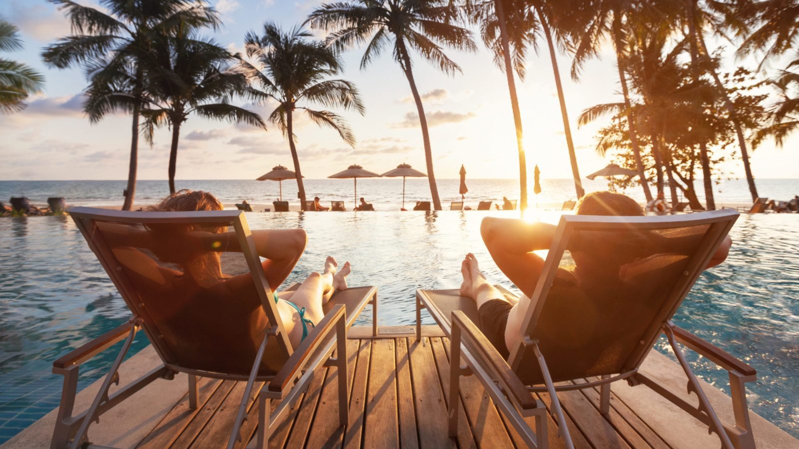 Couple in lounge chairs overlooking water (Photo: Shutterstock)