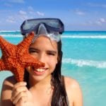 Girl with starfish (Photo: Shutterstock)