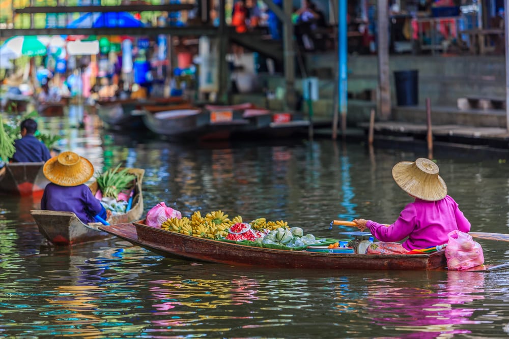 Famous floating market in Thailand, Damnoen Saduak floating market, tourists visiting by boat, Ratchaburi, Thailand. (Photo: Shutterstock)