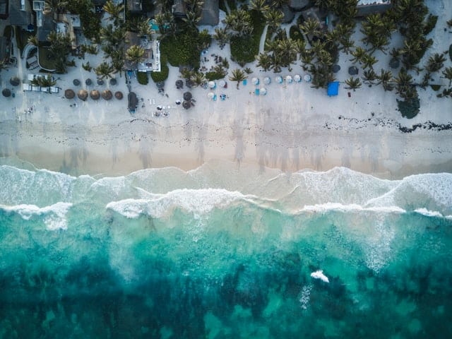 Image of ocean, beach, and resort in Tulum, Mexico