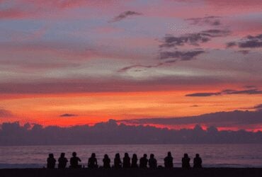 people sitting on sunset beach