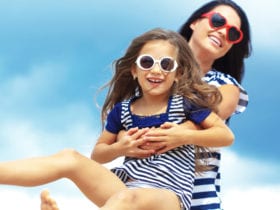 Happy family in sunglasses on beach (Photo: Shutterstock)