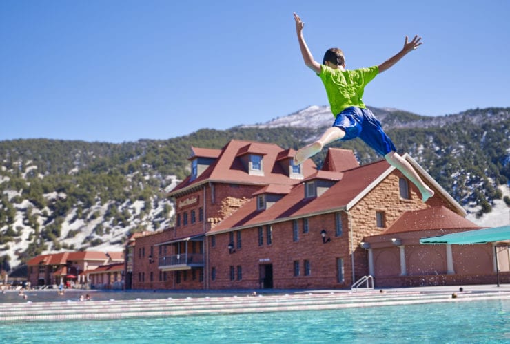 Young Boy Jumps into Pool at Glenwood Hot Springs Resort in Colorado