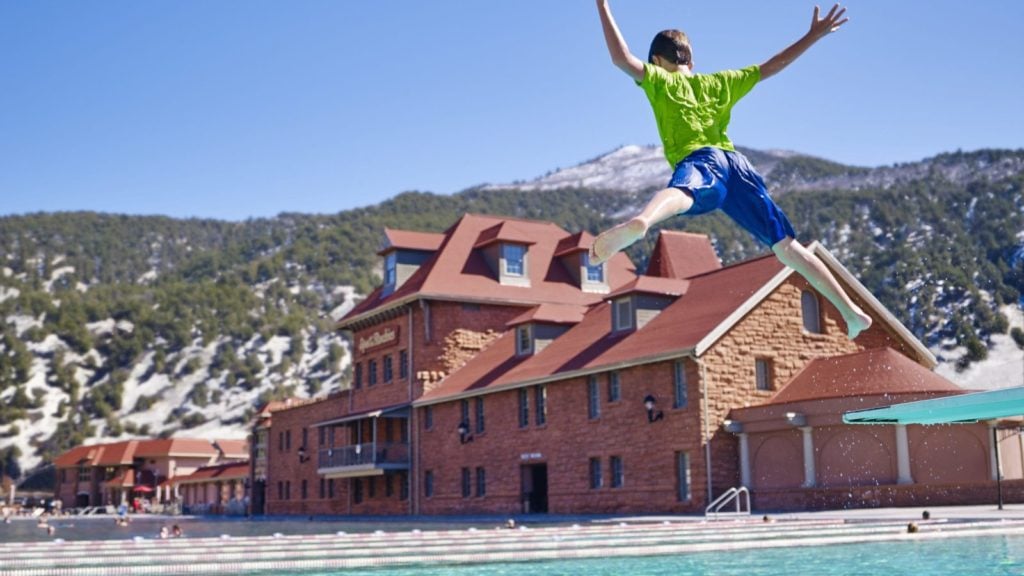 Young Boy Jumps into Pool at Glenwood Hot Springs Resort in Colorado