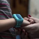 smartwatches for kids: parent holding a child's hand