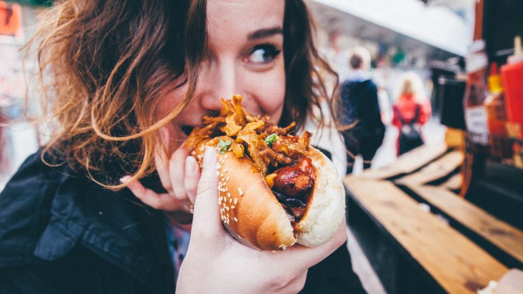 Woman eating street food (Photo: @kaimittak via Twenty20)