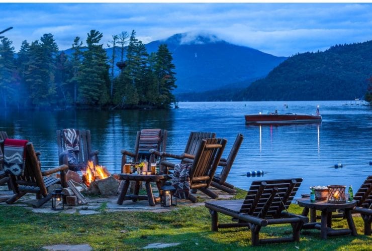 Lake, chairs, and campfire at Whiteface Lodge
