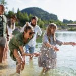 Multigenerational family on walk by lake (Photo: Shutterstock)