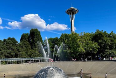 kids playing at a splash pad in Seattle with Space Needle in the background