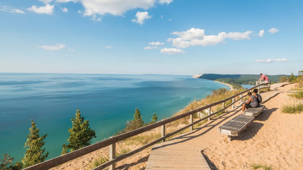 People sitting on benches and taking in the view from Empire Bluff at Sleeping Bear Dunes National Lakeshore