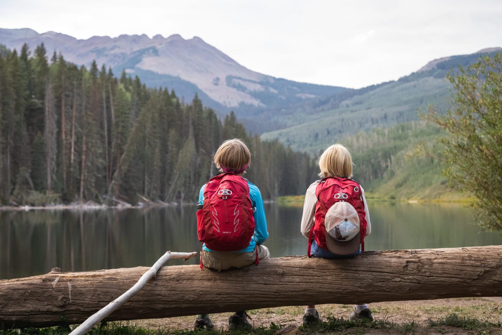 Kids wearing backpacks overlooking a lake (Photo: Osprey)