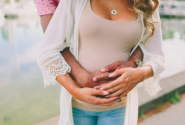 Couple with hands over pregnant belly (Photo: crystalmariesing via Twenty20)