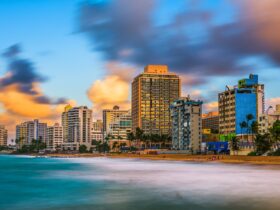 San Juan, Puerto Rico resort skyline on Condado Beach at dusk.