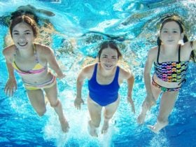 Family swimming underwater in pool (Photo: Shutterstock)