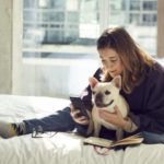 Woman and dog lounging in a pet-friendly hotel room at Aloft Hotels (Photo: Aloft Hotels)