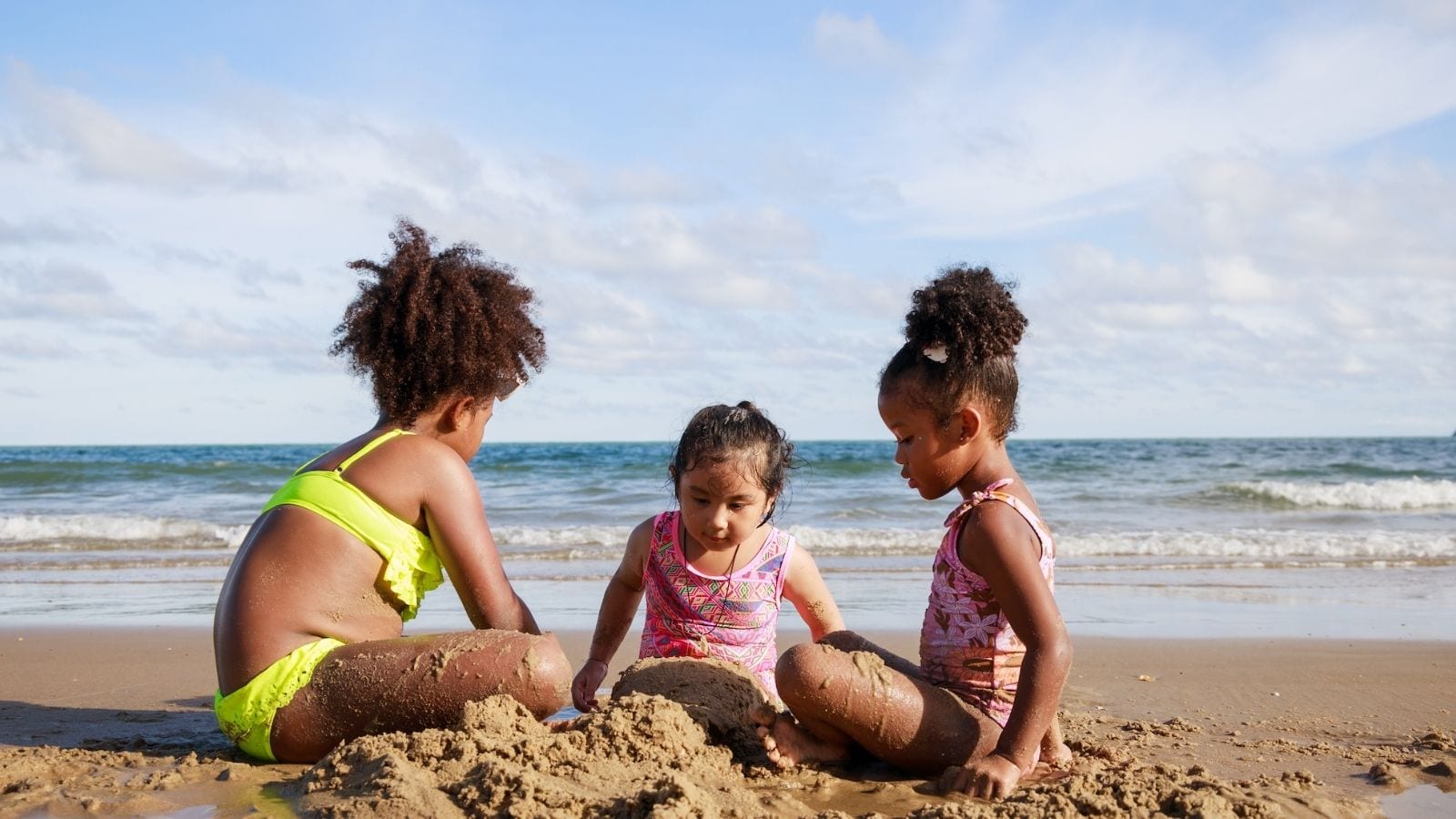 Kids building sandcastles at the beach (Photo: Chayantorn Tongmorn / Shutterstock)