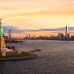 beautiful sky and New York City in background with Statue of Liberty in foreground