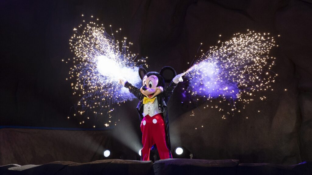 Mickey during Fantasmic with sparklers coming out of his gloves.