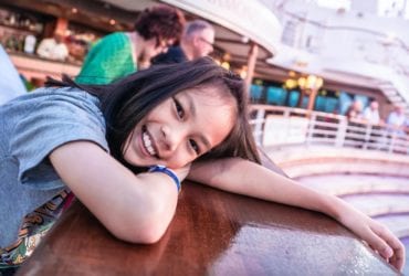 A young girl enjoys a family cruise (Photo: Anutr Yossundara / Shutterstock.com)