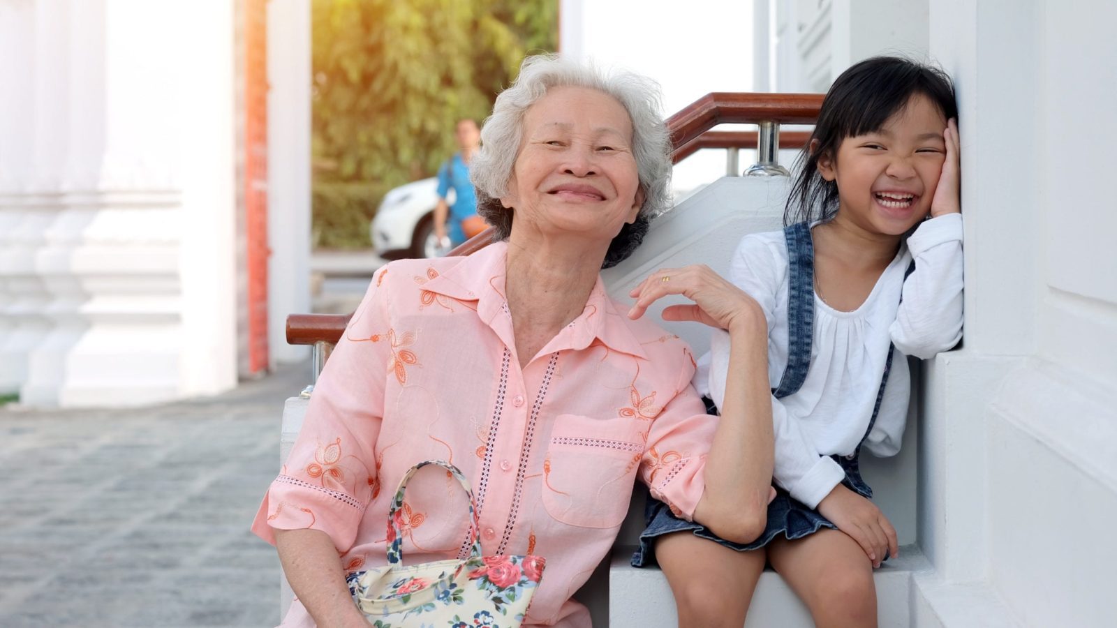 girl on a multi-gen vacation with her grandmother, laughing