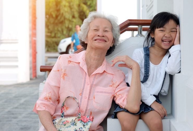 girl on a multi-gen vacation with her grandmother, laughing